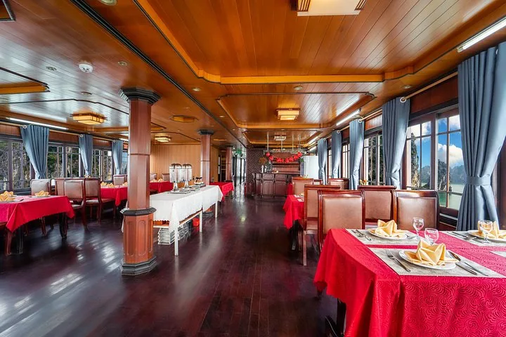 Wooden dining room interior on a boat with tables set for a meal