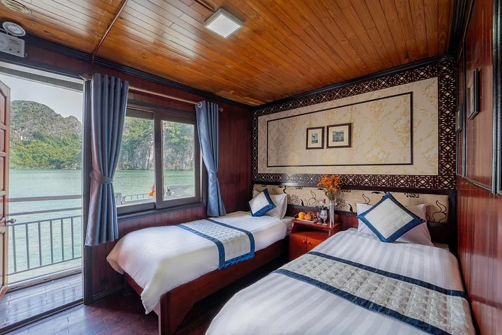 Twin cabin on a cruise ship with a balcony overlooking karst islands