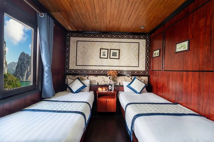 Twin cabin on a boat with large window looking out onto the bay