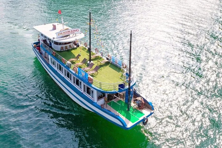 Elevated view of a small blue and white cruise boat from the back